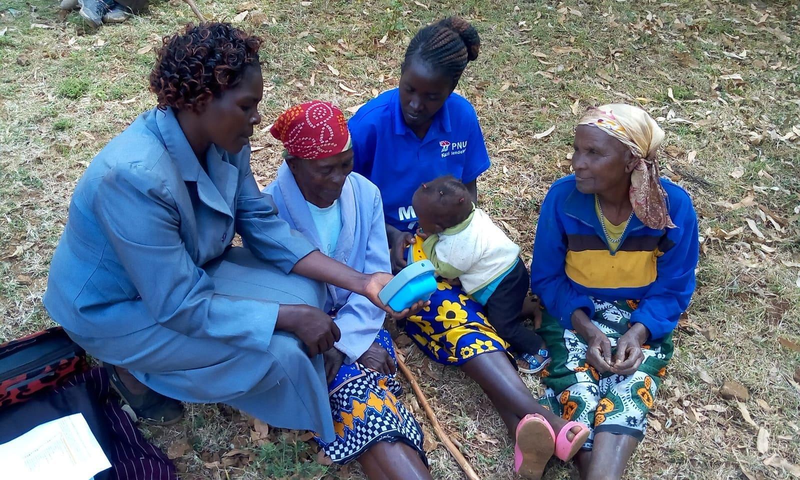 A farm extension worker advising farmers on their land